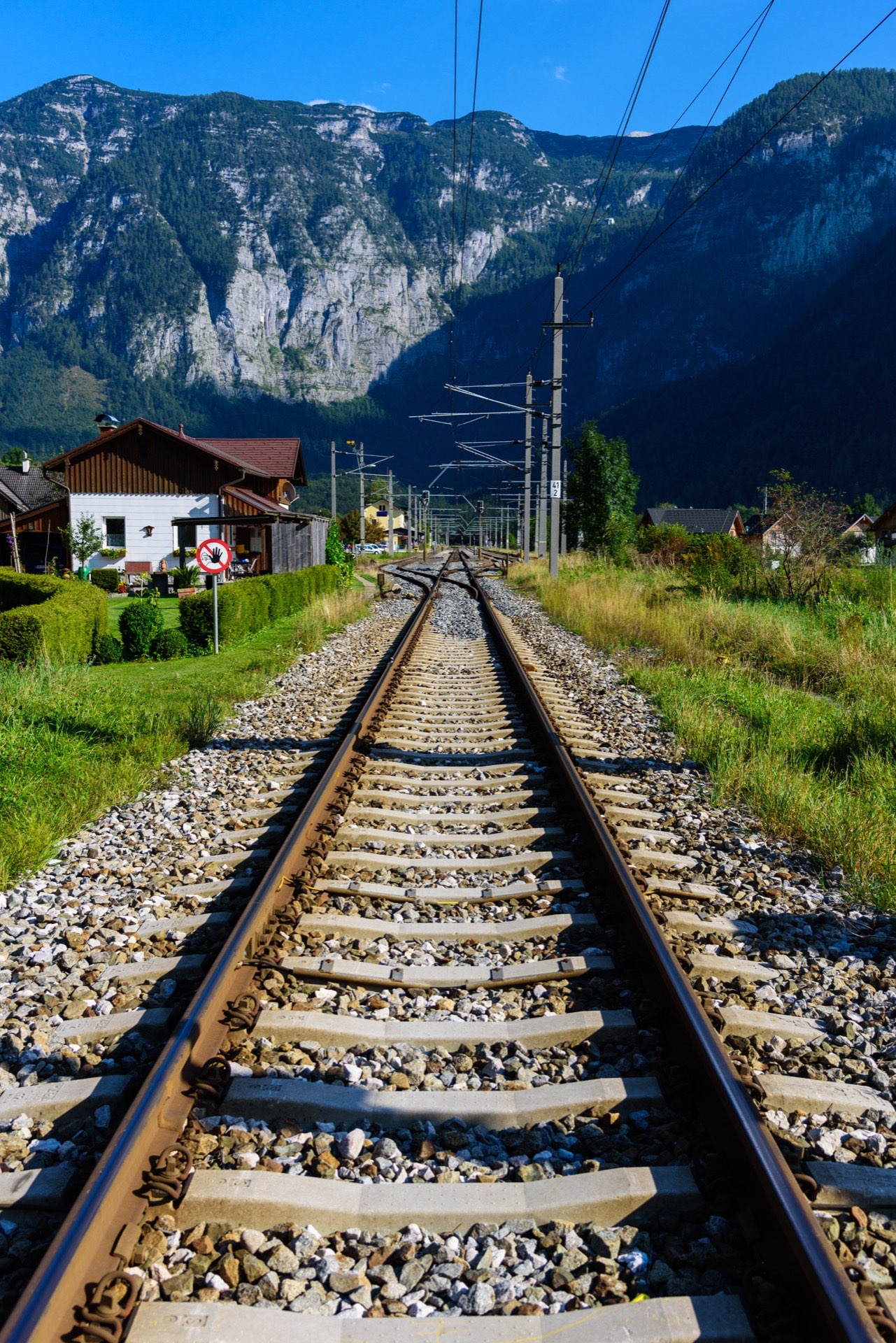Two people overlooking a coastal mountain